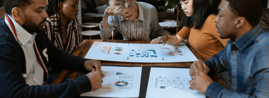 Employees collaborating on team building strategies around a conference table